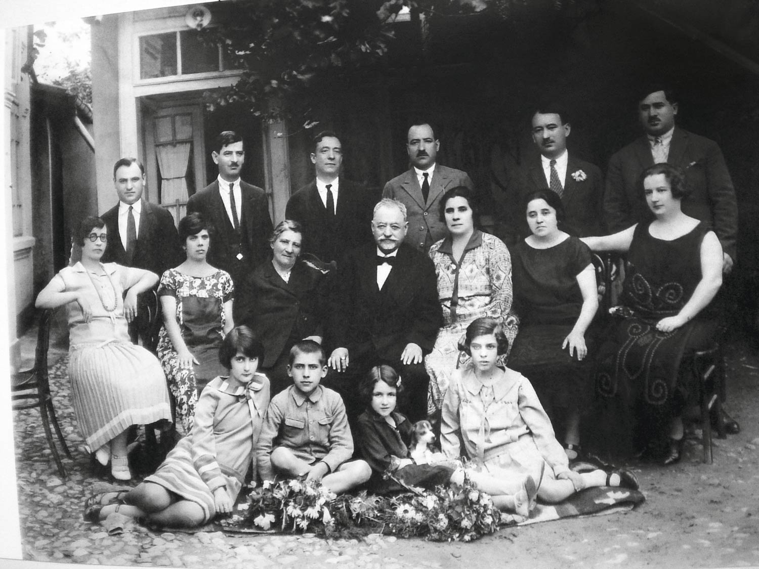 The Romanian Steinbergs with visiting American relatives, Buzău, 1925. Moritz Steinberg is in the top row, second from right, with his brothers and brother-in-law. Rosa Steinberg is seated, third from right; Clara and Nachman Steinberg to the left of her. Seated on the ground: Henrietta Steinberg, an American cousin, Saul, Gertrude Steinberg, an American cousin, and Lica Steinberg.