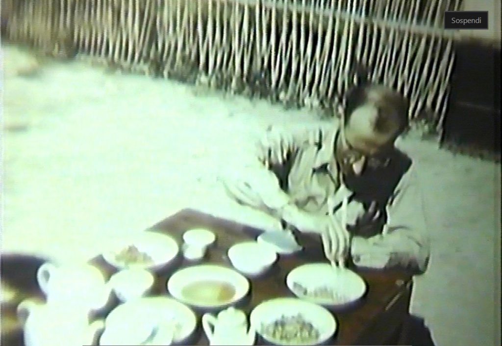 Frame from a film made by SACO, Steinberg eating with chopsticks at SACO headquarters in Happy Valley, China, 1943