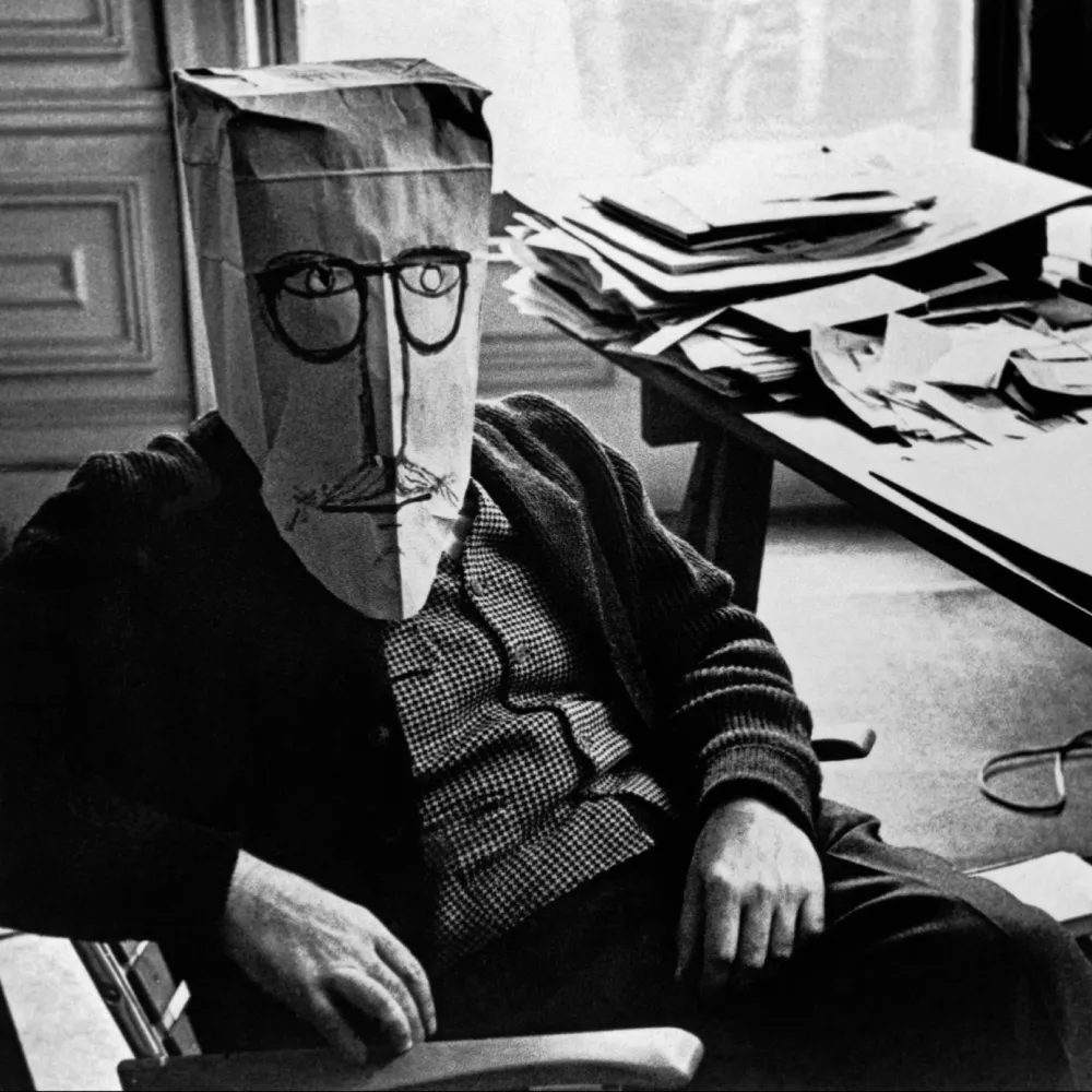 Saul wearing one of his paper bag mask at his desk.